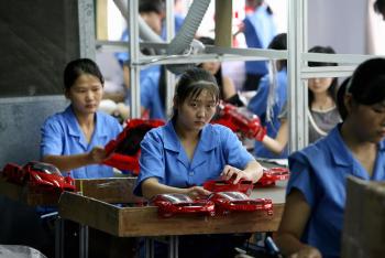 This photo taken 25 September, 2007 shows workers on a production line at a toy factory in Shantou, in China's eastern Guangdong province. Image credit: AFP/Getty Images