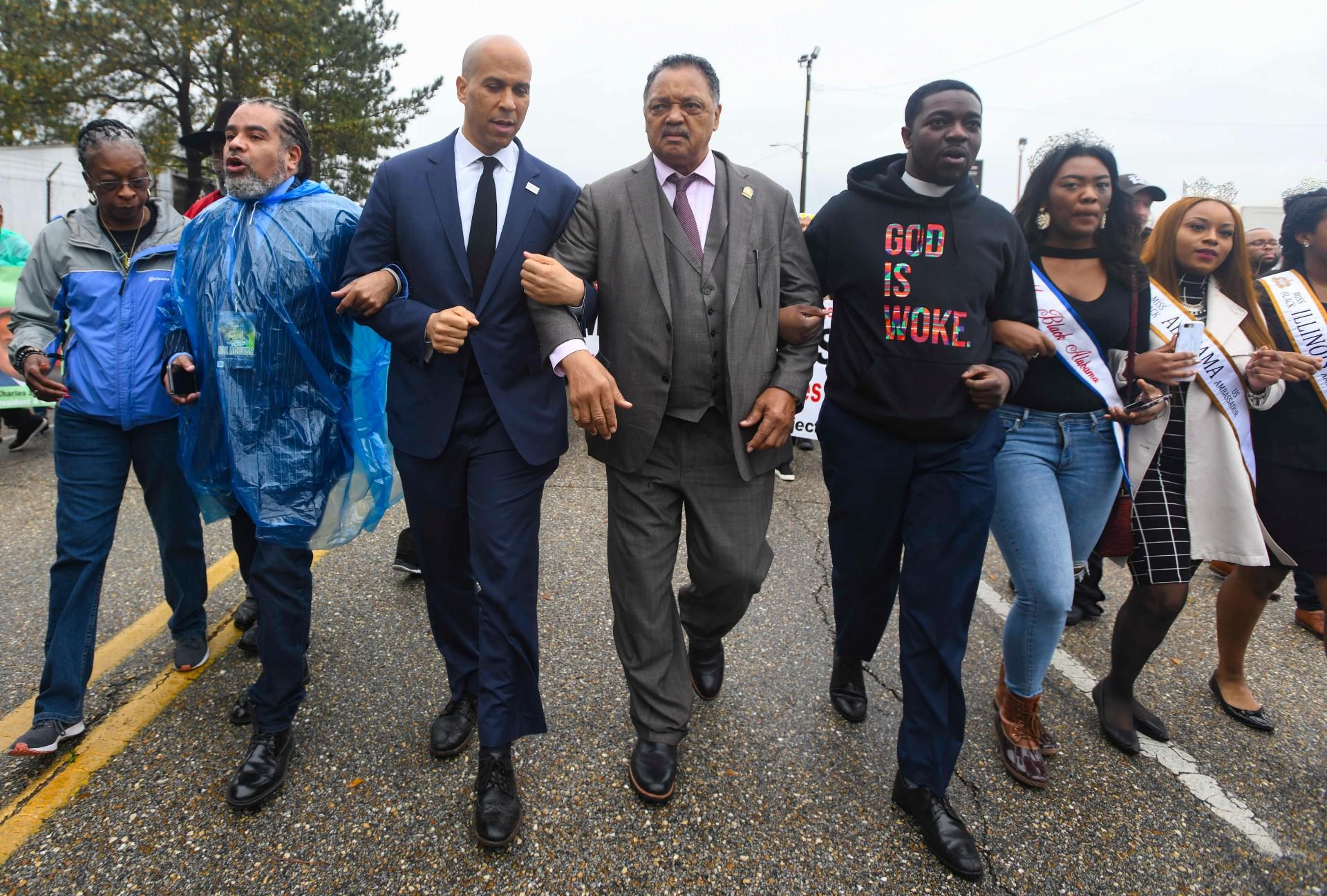 U.S. Sen. Cory Booker, D-N.J., third from left, and the Rev. Jesse Jackson march to cross the Edmund Pettus Bridge Sunday, March 3, 2019, during the Bloody Sunday commemoration in Selma, Ala. The infamous “Bloody Sunday” on March 7, 1965, galvanized support for the passage of the Voting Rights Act that year. (AP Photo / Julie Bennett)