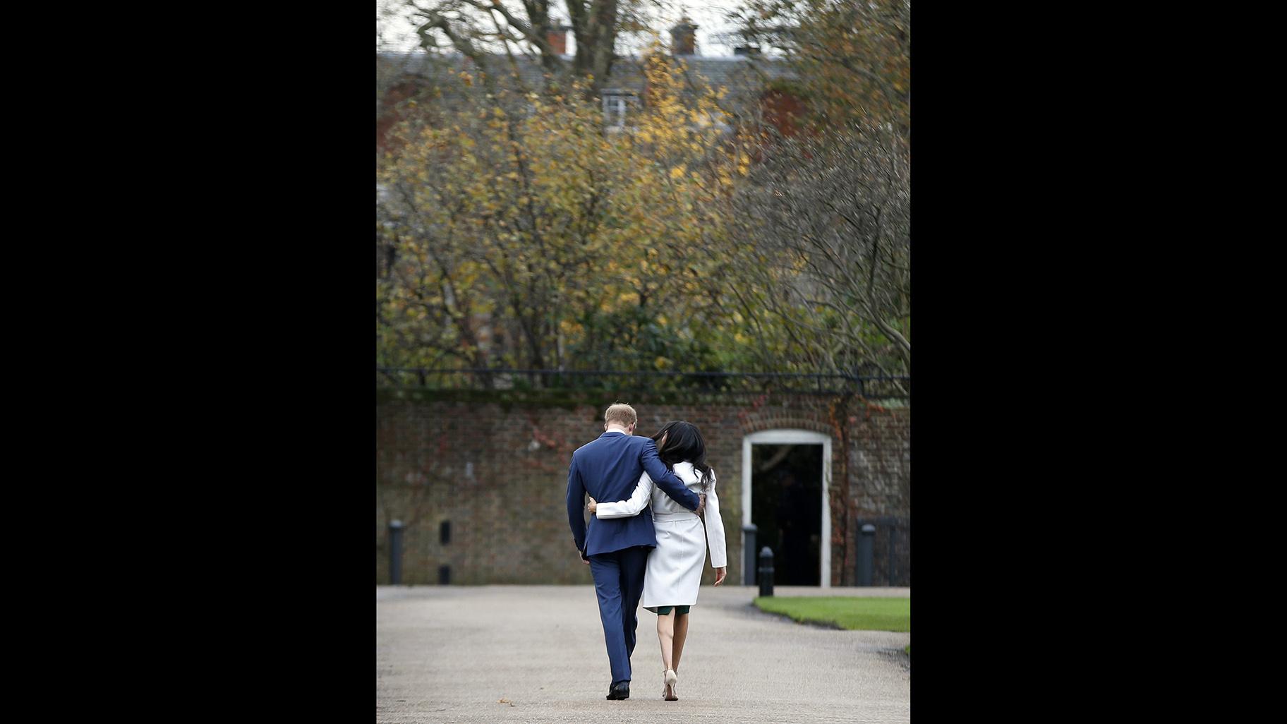 In this Monday Nov. 27, 2017 file photo, Britain’s Prince Harry and Meghan Markle walk away after posing for the media in the grounds of Kensington Palace in London. (AP Photo / Alastair Grant, File)
