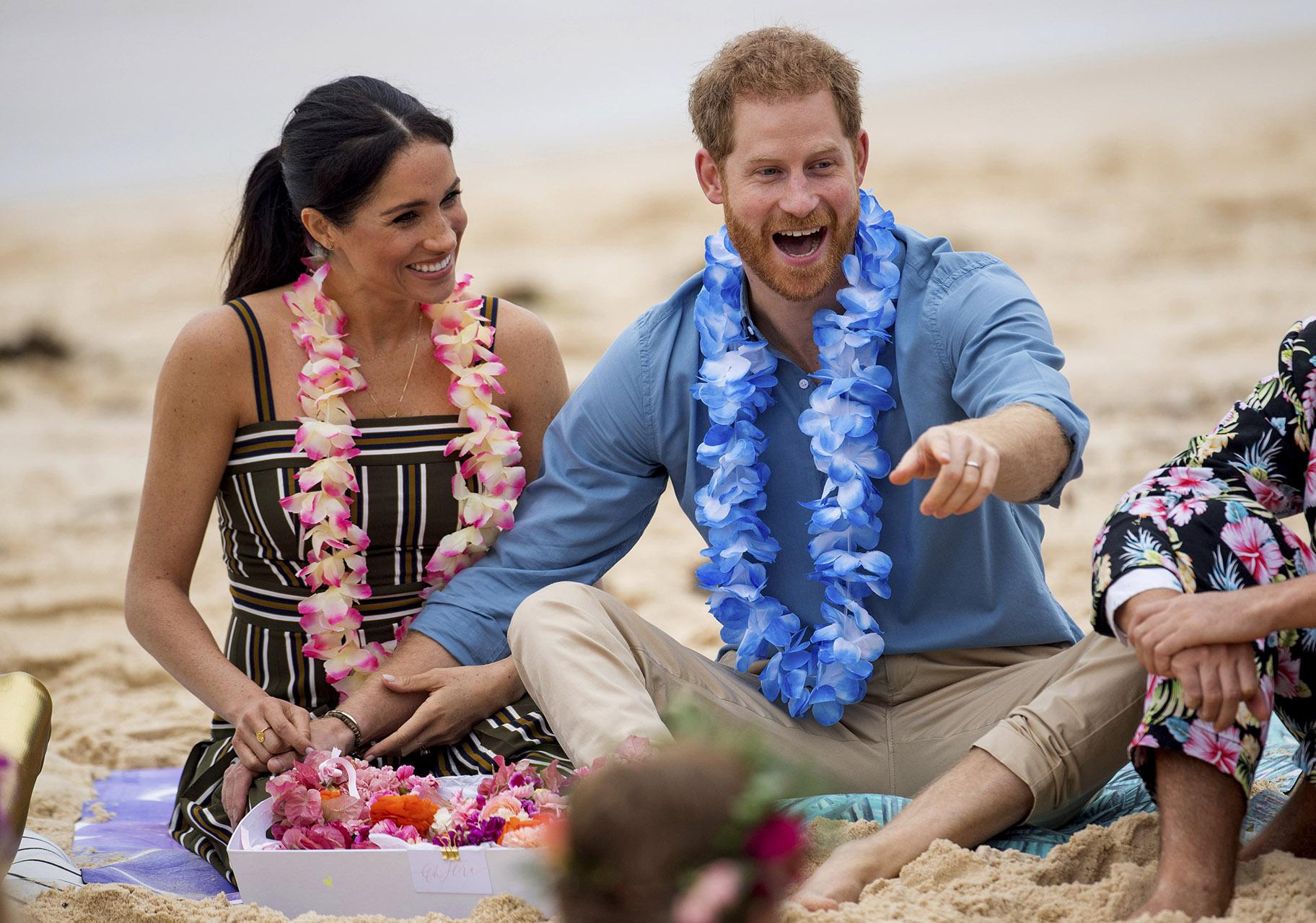 In this Friday, Oct. 19, 2018 file photo, Britain’s Prince Harry and Meghan, Duchess of Sussex, meet with a local surfing community group, known as OneWave, raising awareness for mental health and wellbeing in a fun and engaging way at Bondi Beach in Sydney, Australia. (Dominic Lipinski / Pool via AP)