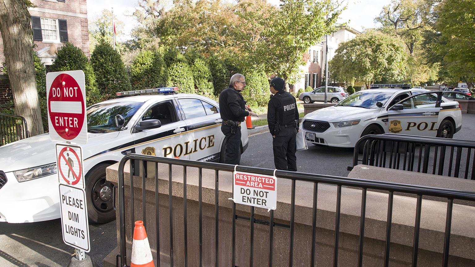 Officers with the Uniform Division of the United States Secret Service talk at a checkpoint near the home of former President Barack Obama on Wednesday, Oct. 24, 2018, in Washington, D.C. (AP Photo / Alex Brandon)