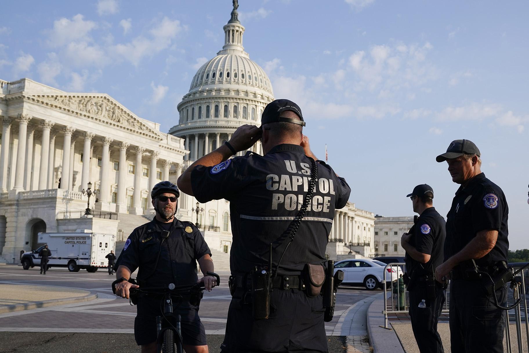 The U.S. Capitol is seen in Washington, early Tuesday, July 27, 2021, as U.S. Capitol Police watch the perimeter. (AP Photo / J. Scott Applewhite)