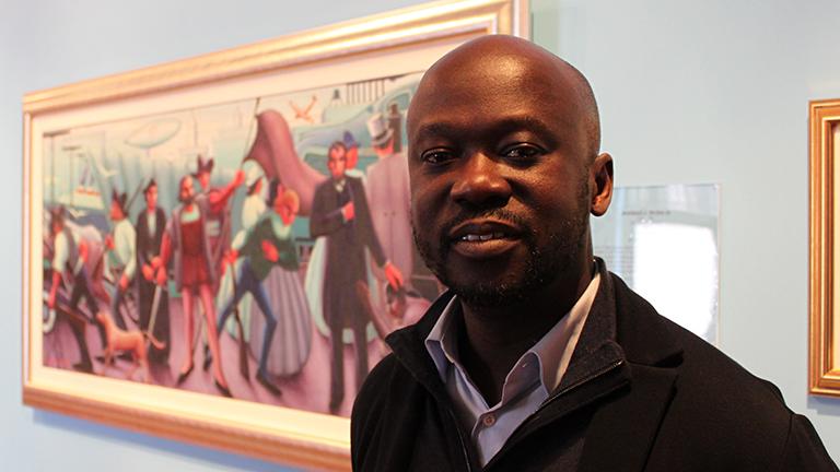 Architect David Adjaye, a finalist for the Obama Presidential Center, stands before Archibald Motley's "Progressive America" at the DuSable Museum on Tuesday.