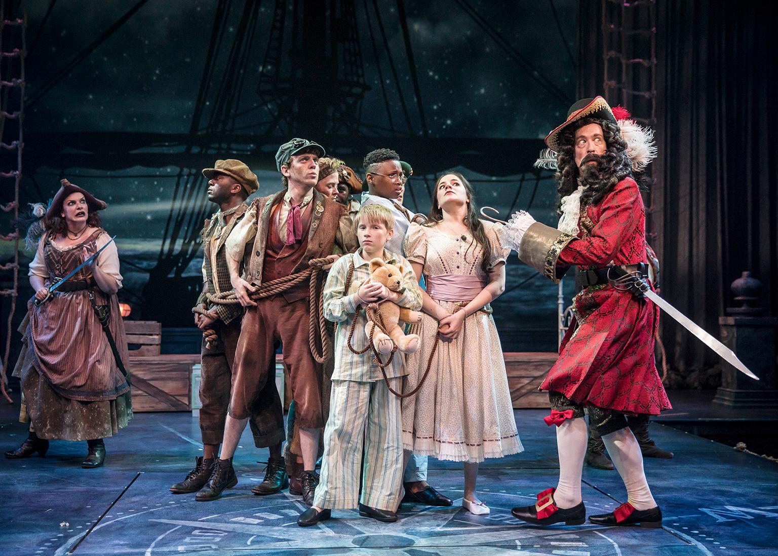 Captain Hook (James Konicek) taunts the captured Lost Boys and Darling siblings, with the help of Starkey (Christina Hall) in “Peter Pan – A Musical Adventure.” (Photo by Liz Lauren)