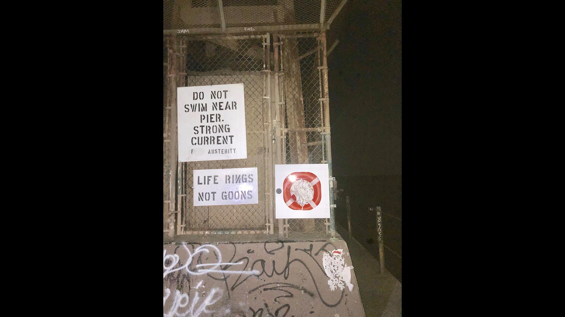 A photo edited by WTTW News to blur out a curse word shows a life ring installed on the lakefront by Rogers Park activist Jim Ginderske. Other residents put up anti-Park District signage, which was also removed. (Credit Jim Ginderske)