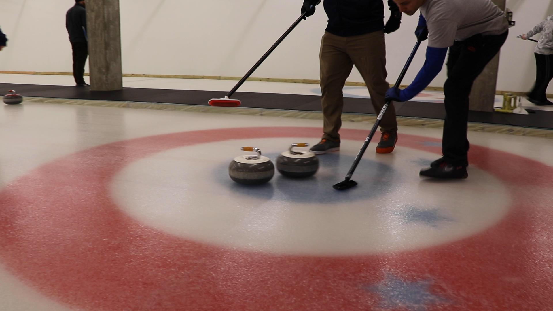 Curlers score when they slide their stone closer to the house’s center compared to their opponent. (Evan Garcia / WTTW News)