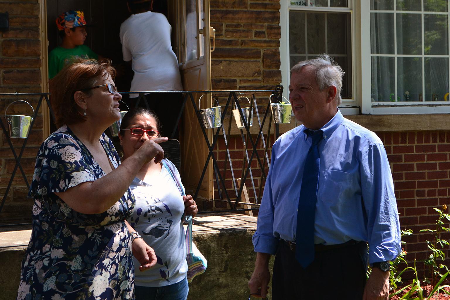 U.S. Sen. Dick Durbin talks with a Southeast Side resident outside of her home Thursday. (Alex Ruppenthal / Chicago Tonight)