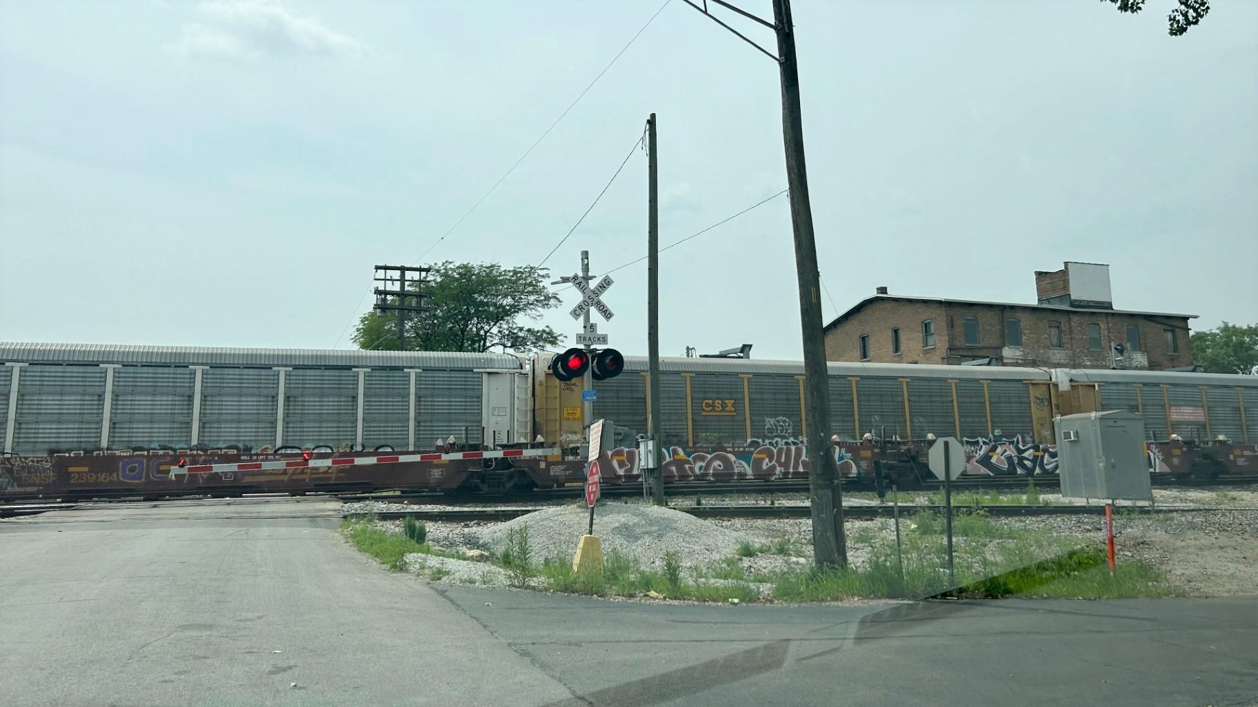 A railroad crossing south of 139th Street and Seeley Avenue in Thornton Township. On June 30, 2023, a WTTW News producer waited 37 minutes for the train to pass. (Jared Rutecki / WTTW News)