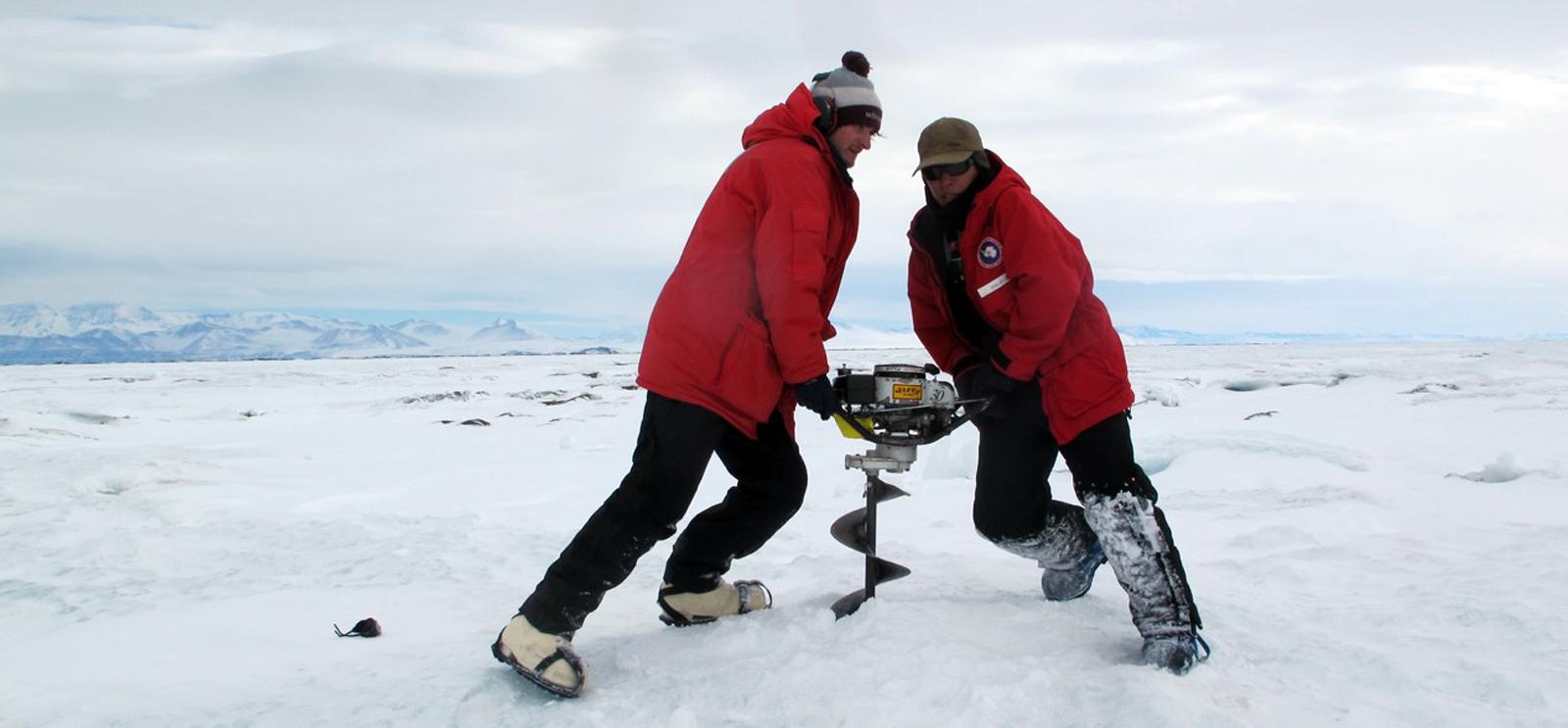 A University of Chicago graduate student works with a National Science Foundation collaborator to install a seismometer in an Antarctican ice shelf. (Doug MacAyeal / University of Chicago)