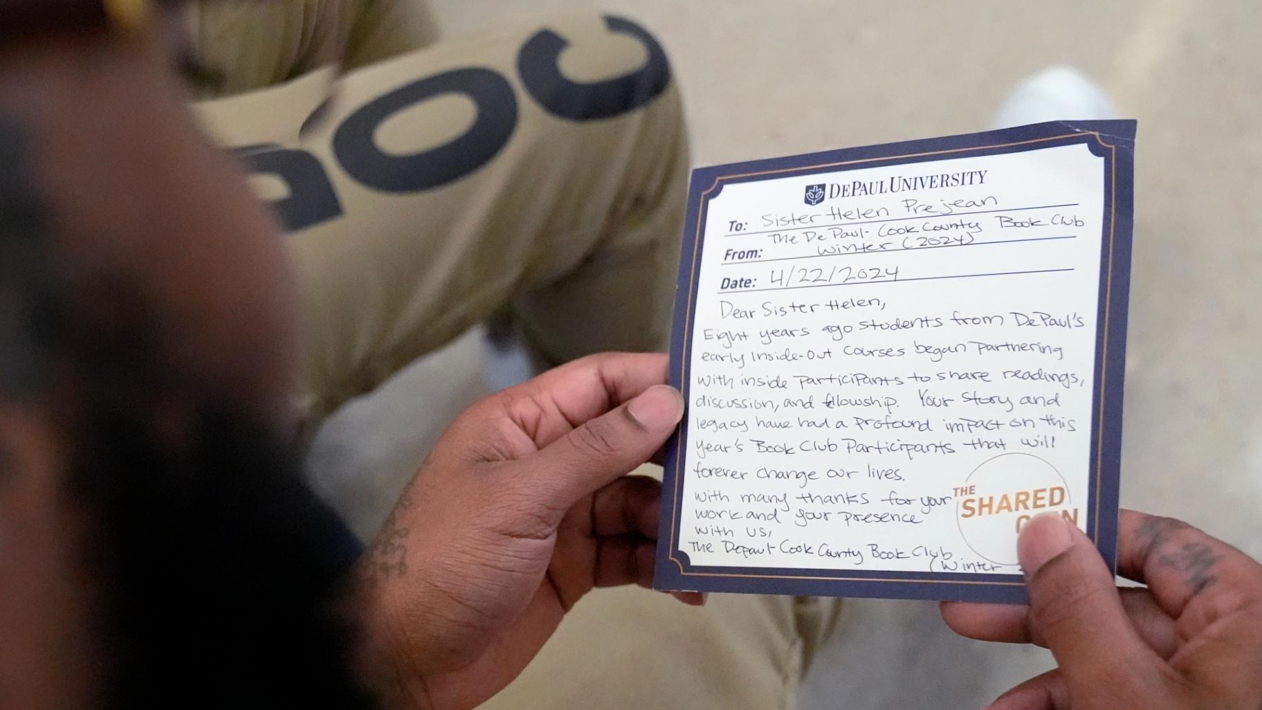 Stanley Allen, detainee in Division Of Correction 11, reads a note for Sister Helen Prejean during a book club at Department Of Corrections Division 11 in Chicago, Monday, April 22, 2024. (Nam Y. Huh / AP Photo)