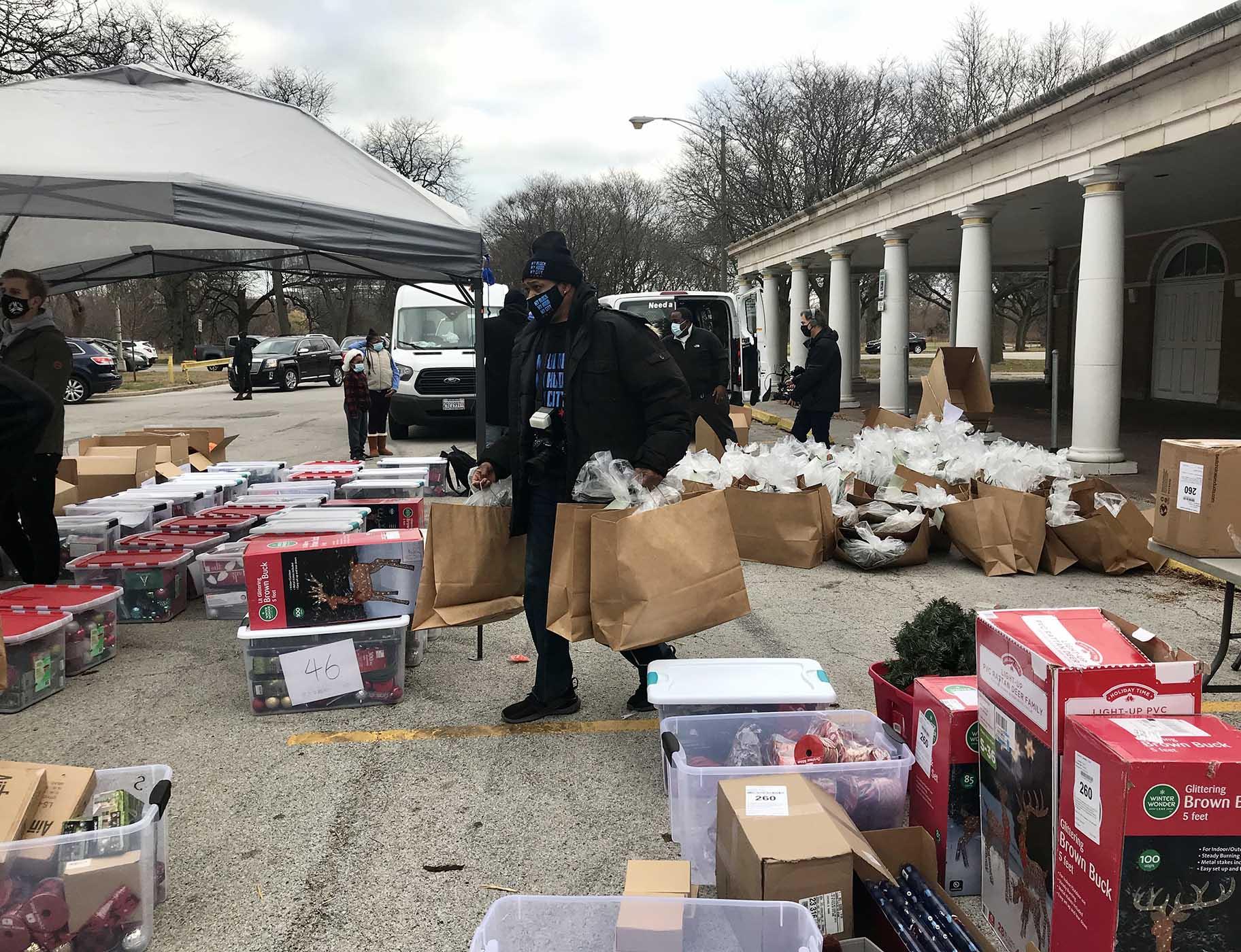 Volunteers distribute a mass of holiday lights, wreaths, ornaments and other decor. (Ariel Parrella-Aureli / WTTW News)