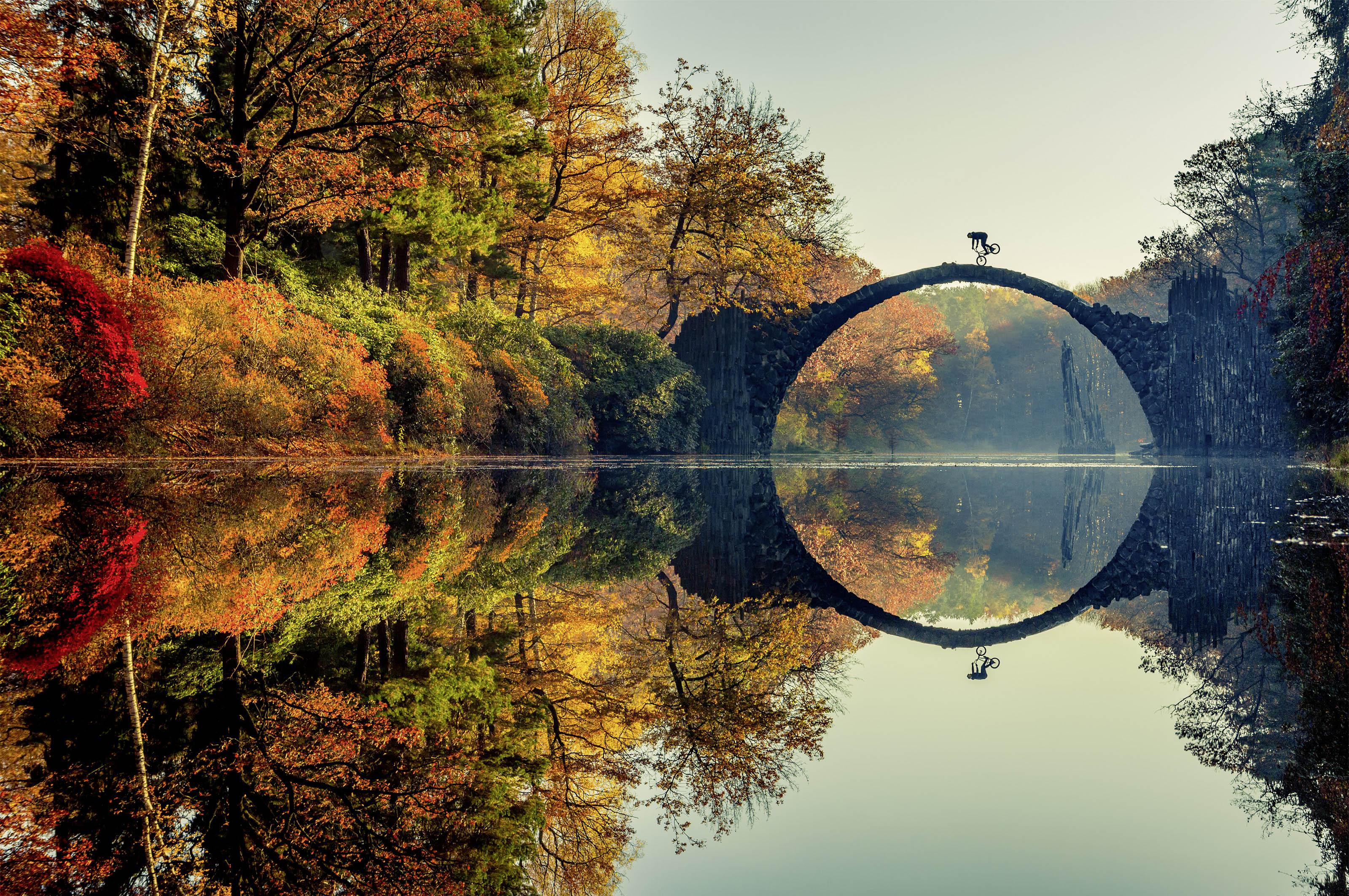 Lorenz Holder of Germany was the overall winner of the 2016 Red Bull Illume contest. The photo shows Senad Grosic ride his bike over a bridge in an autumnal Gablenz, Germany. (Lorenz Holder / Red Bull Illume)
