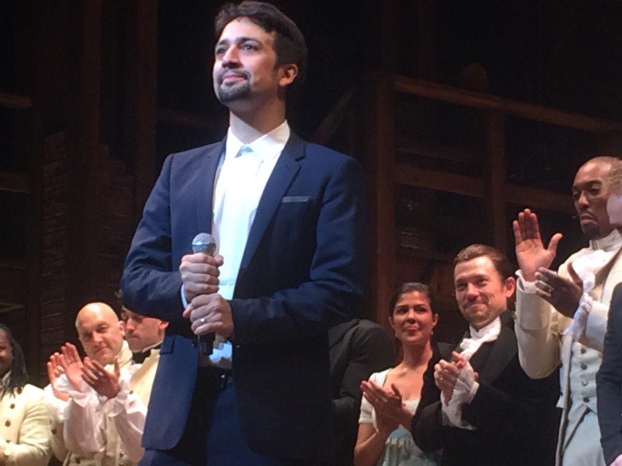 Lin-Manuel Miranda appears on stage at the opening night of “Hamilton” in Chicago on Oct. 19. Actor Miguel Cervantes appears in the background, at right, in black. (Marc Vitali / Chicago Tonight)