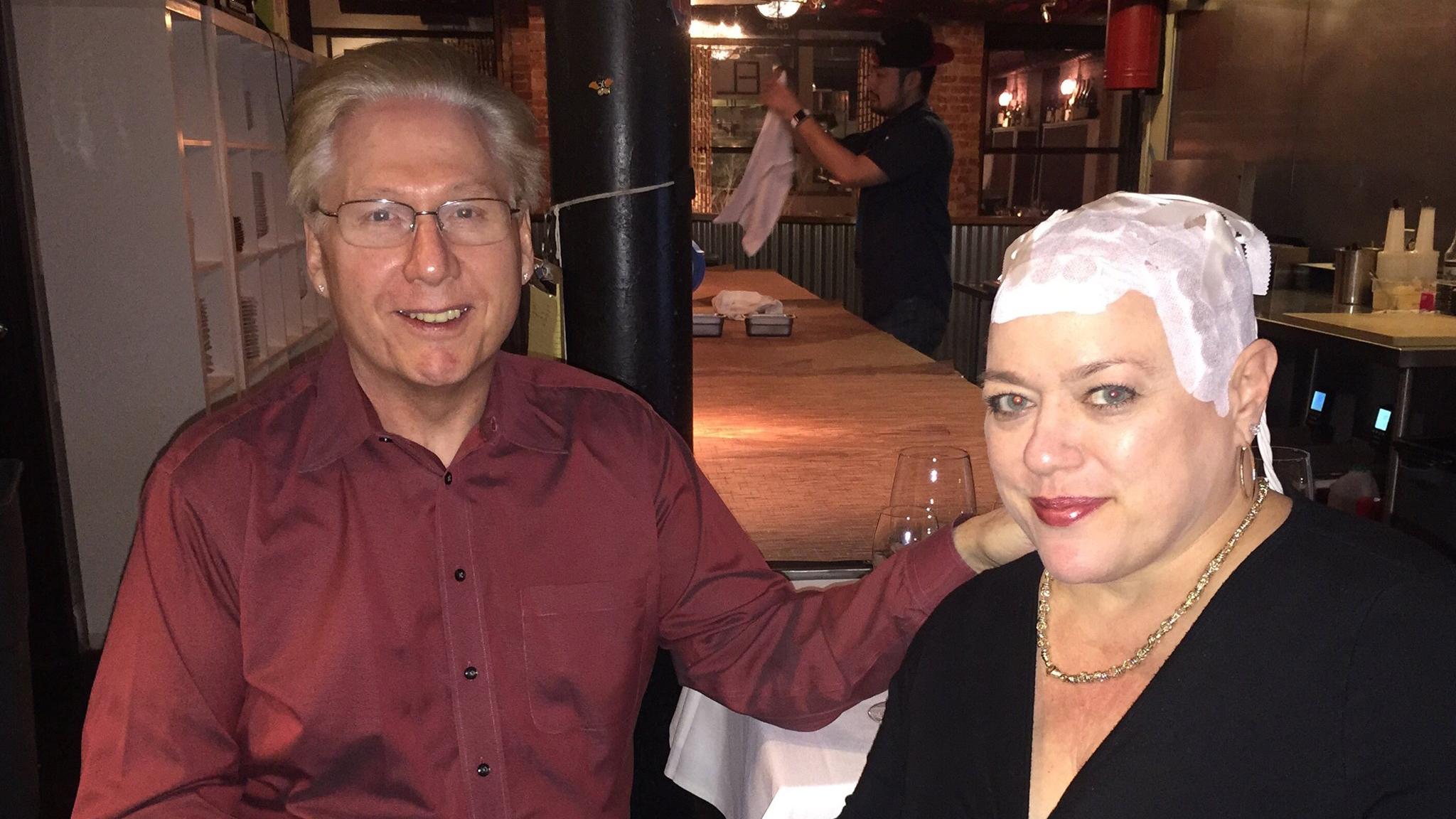 “I never cover it. I do put a light color hat on it to keep the sun off of it but I don’t wear a wig or cap every day,” said Joyce Endresen, who was diagnosed with glioblastoma and uses a skull-worn electric fields cap while dining at a restaurant with her husband, Hal. (Courtesy Joyce Endresen)