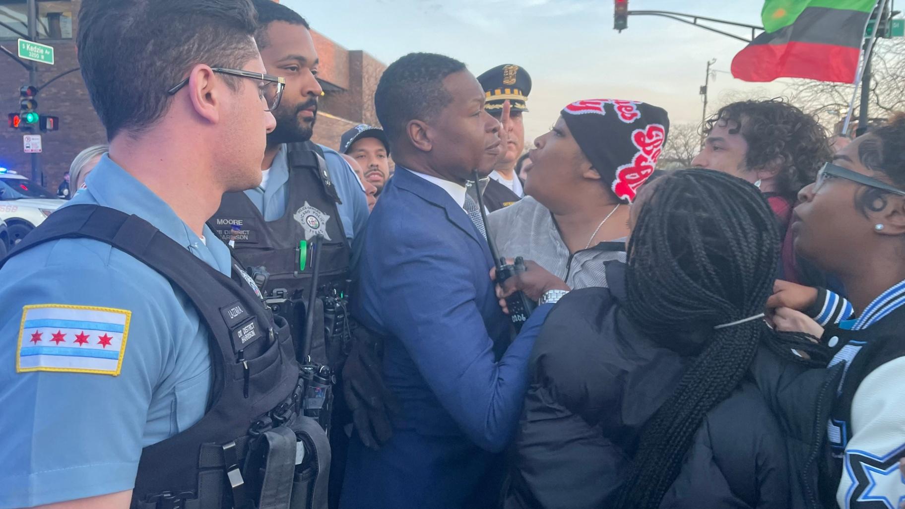 Porscha Banks, center, confronts Chicago police officers at a protest outside the 11th Police District headquarters on April 9, 2024, hours after video of the fatal police shooting of her brother, Dexter Reed, was released. (Heather Cherone / WTTW News)