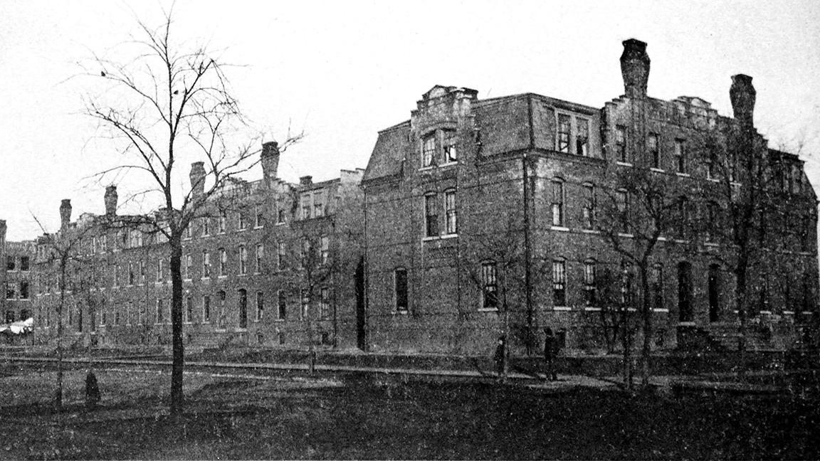 A historic photo shows the three tenement buildings in Pullman where a new loft development is planned. The middle building was demolished in 1939. (“Pullman: City of Brick,” H. R. Koopman, 1893)