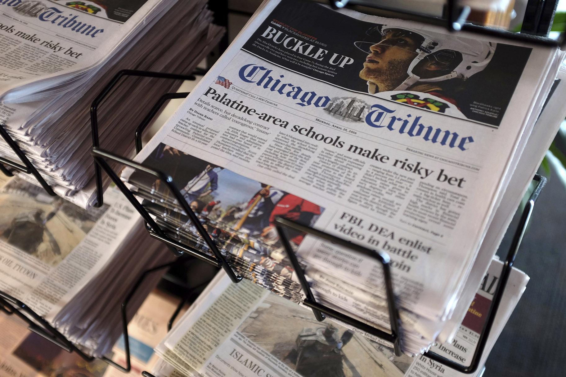 In this Monday, April 25, 2016, file photo, Chicago Tribune and other newspapers are displayed at Chicago’s O’Hare International Airport. (AP Photo / Kiichiro Sato, File)