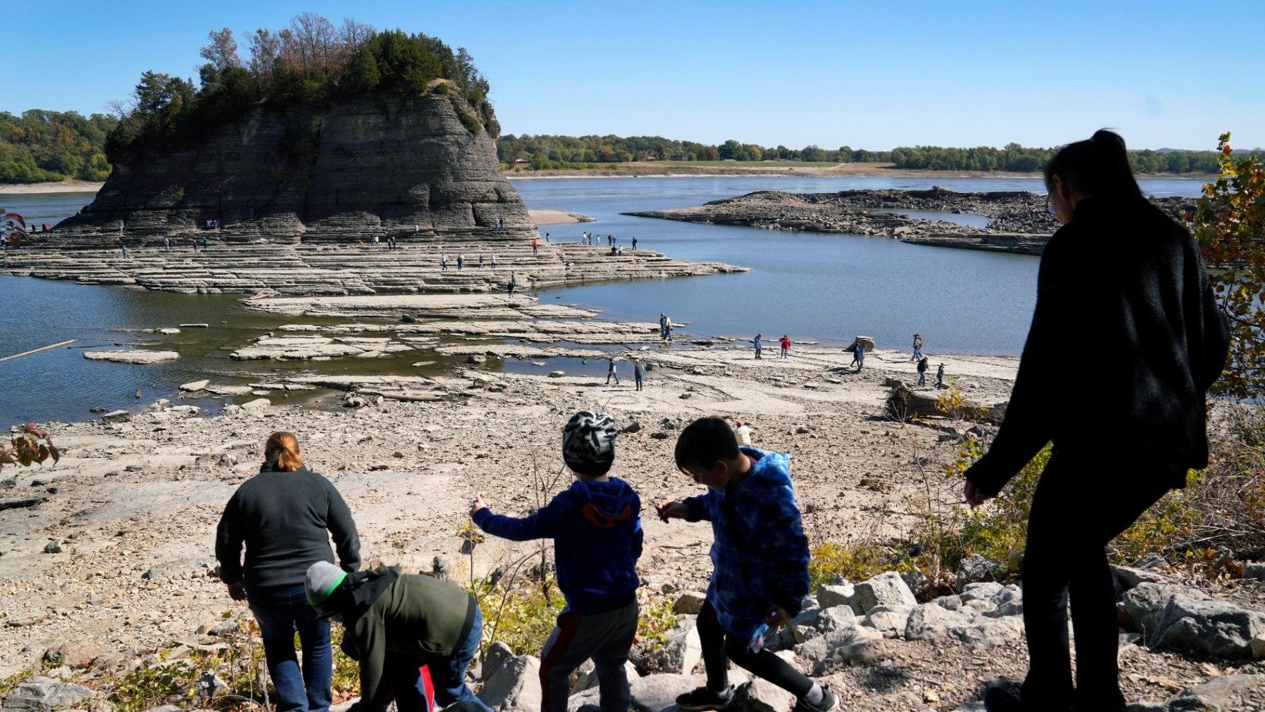 People walk toward Tower Rock to check out the attraction normally surrounded by the Mississippi River and only accessible by boat, Oct. 19, 2022, in Perry County, Mo. Foot traffic to the rock formation has been made possible because of near record low water levels along the river. (AP Photo / Jeff Roberson, File)