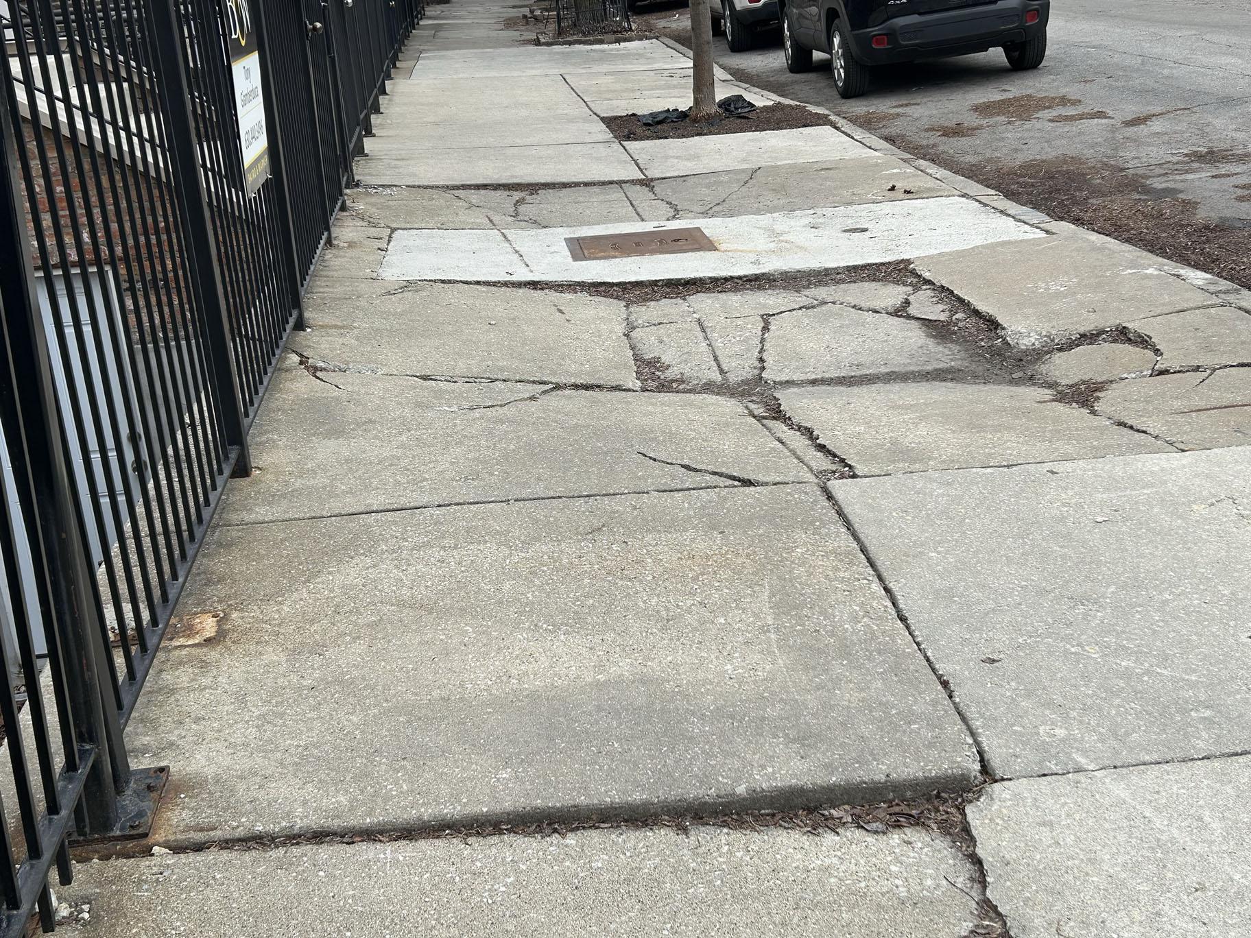 A sidewalk in front of a home on West Pierce Avenue in the Wicker Park neighborhood has had 10 inspection requests made through 311. (Jared Rutecki / WTTW News)