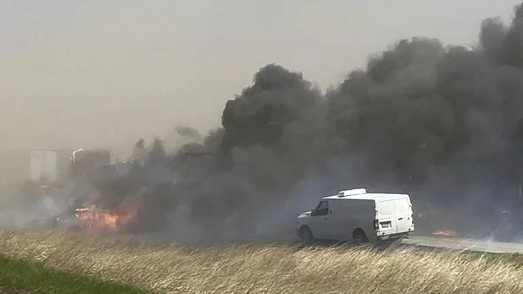 Smoke billows after a crash involving at least 20 vehicles shut down a highway in Illinois, Monday, May 1, 2023. Illinois State Police say a windstorm that kicked up clouds of dust in south-central Illinois led to numerous crashes and multiple fatalities on Interstate 55. (WICS TV via AP)