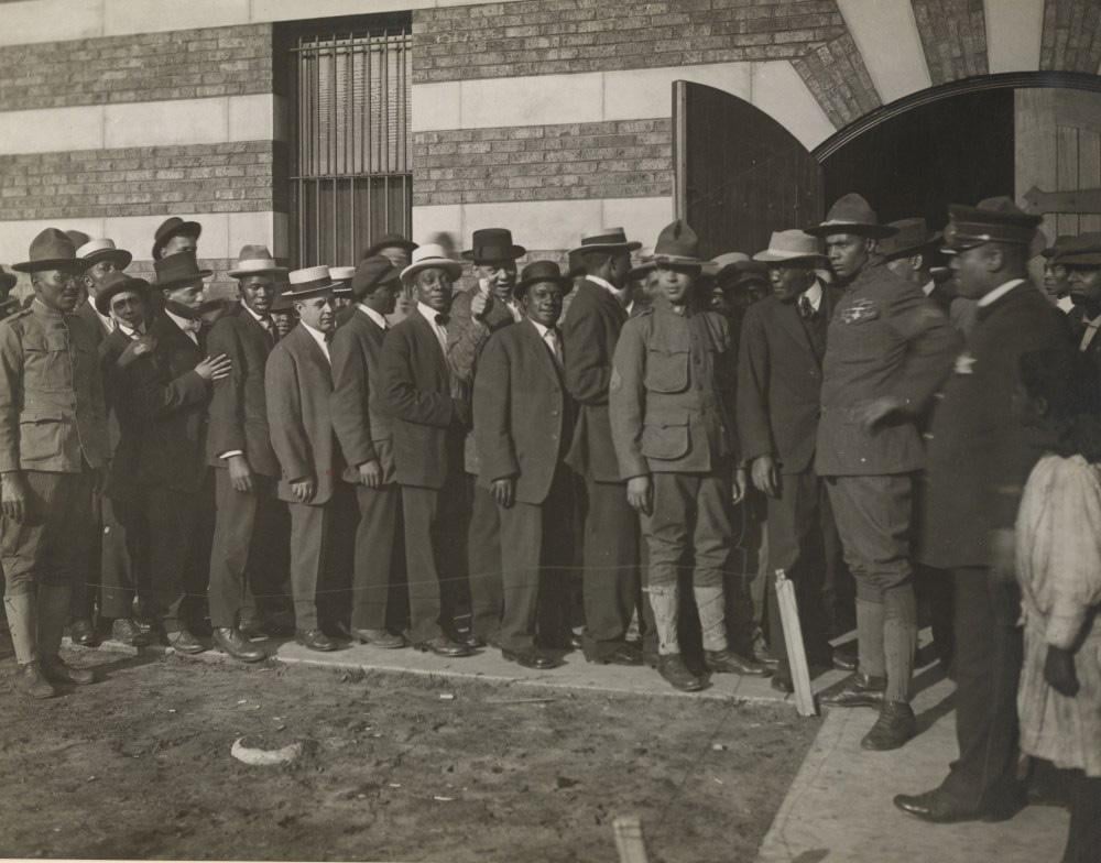 Men line up to enlist in World War I. Though many thought African-Americans only held service jobs during the war, they also comprised a handful of infantry units. (Courtesy of Christopher Reed)
