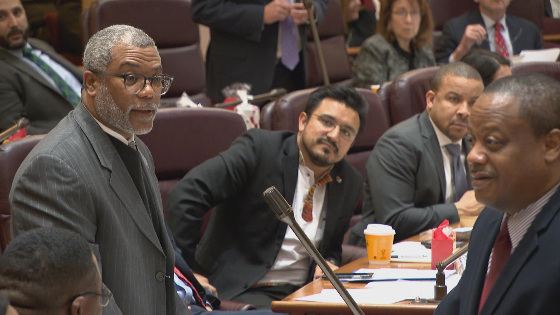 Ald. Walter Burnett, left, clarifies his use of the word “bump” during a tension-filled City Council meeting on Wednesday, Dec. 18, 2019. (WTTW News)