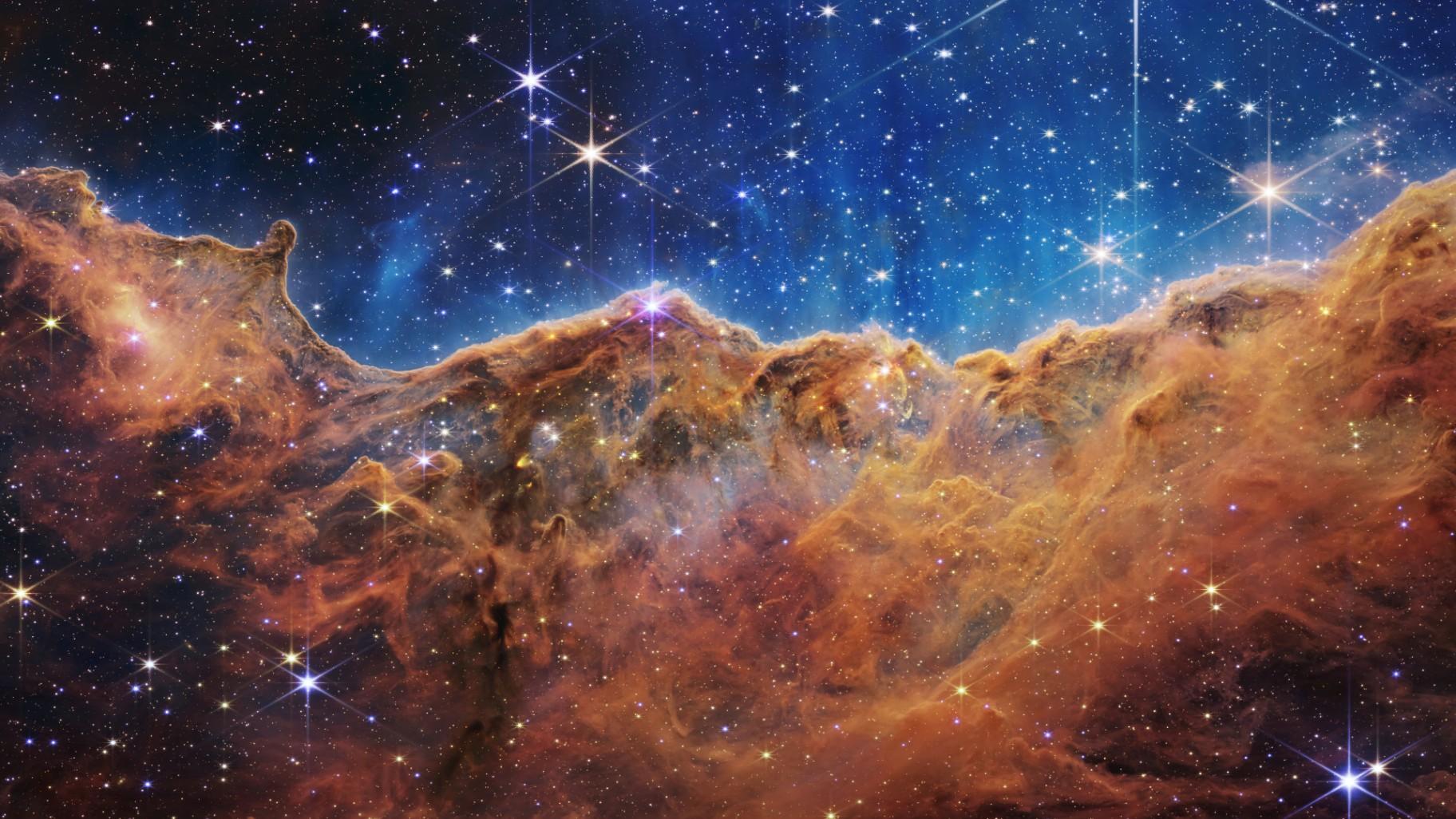 This image released by NASA on Tuesday, July 12, 2022, shows the edge of a nearby, young, star-forming region NGC 3324 in the Carina Nebula. (NASA, ESA, CSA, and STScI via AP)