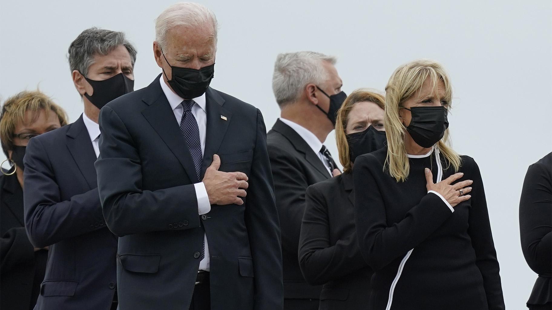 President Joe Biden and first lady Jill Biden watch as a carry team moves the transfer case containing the remains of Navy Corpsman Maxton W. Soviak, 22, of Berlin Heights, Ohio, during a casualty return Sunday, Aug. 29, 2021, at Dover Air Force Base, Del. (AP Photo / Carolyn Kaster)