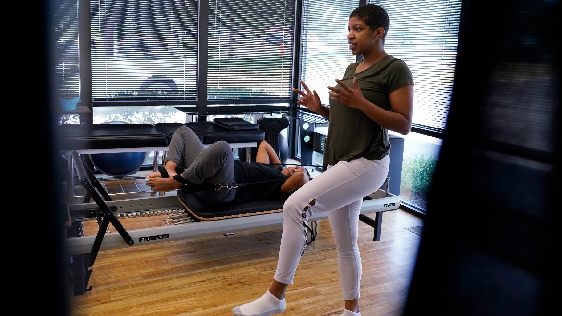 Healthcare instructor Aolion Doxie, right, works with Jamila Thomas at Naperville Wellness & Salt Cave in Naperville, Ill., Thursday, June 8, 2023. (AP Photo / Nam Y. Huh)