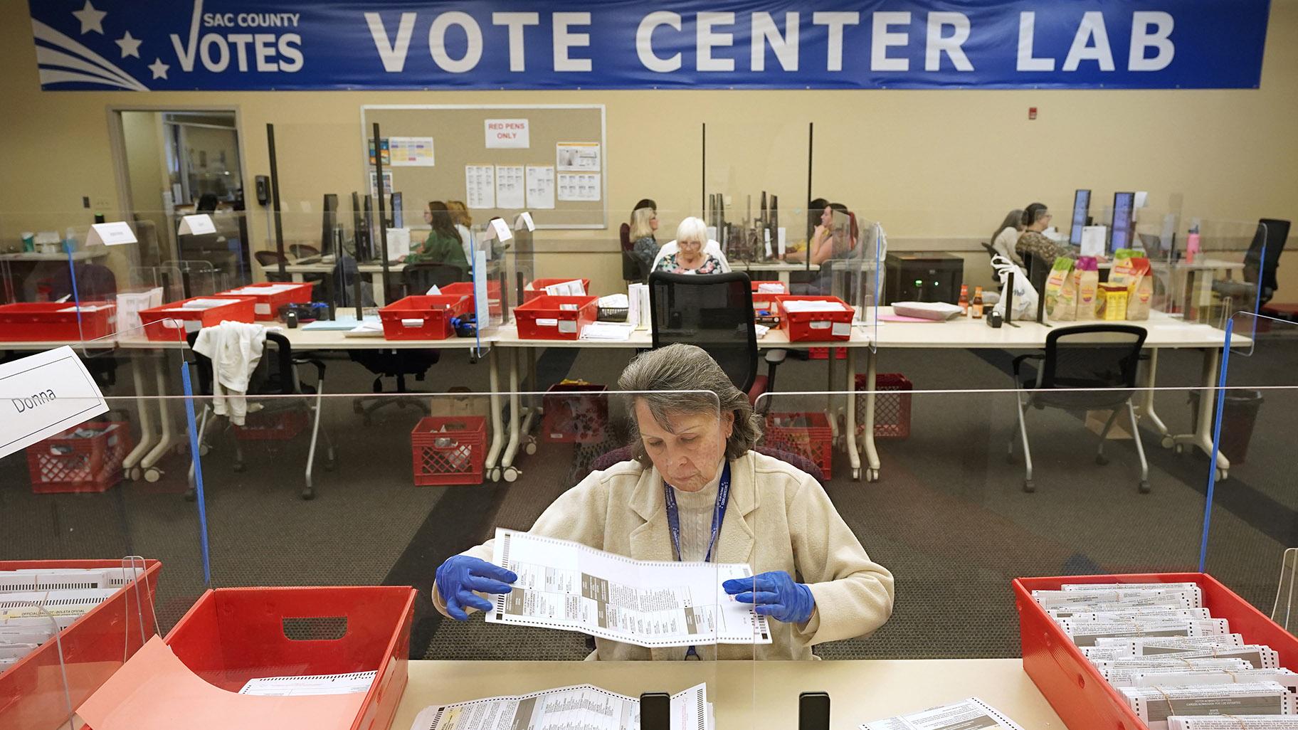 Election worker Donna Young inspects a mail-in ballot for damage at the Sacramento County Registrar of Voters in Sacramento, Calif., June 3, 2022. (AP Photo / Rich Pedroncelli, File)