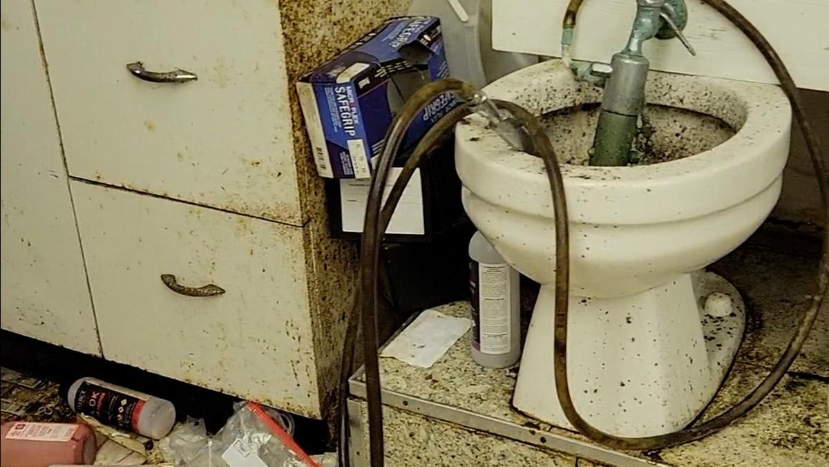 Screenshots from a video show leaky pipes, piles of trash and generally filthy conditions in what a source identified as the embalming room of the Moran Queen-Boggs Funeral Home in Centralia. The source who provided the video requested anonymity due to safety concerns. The funeral home’s director, Hugh Moran, would not confirm its authenticity. (Photos provided)