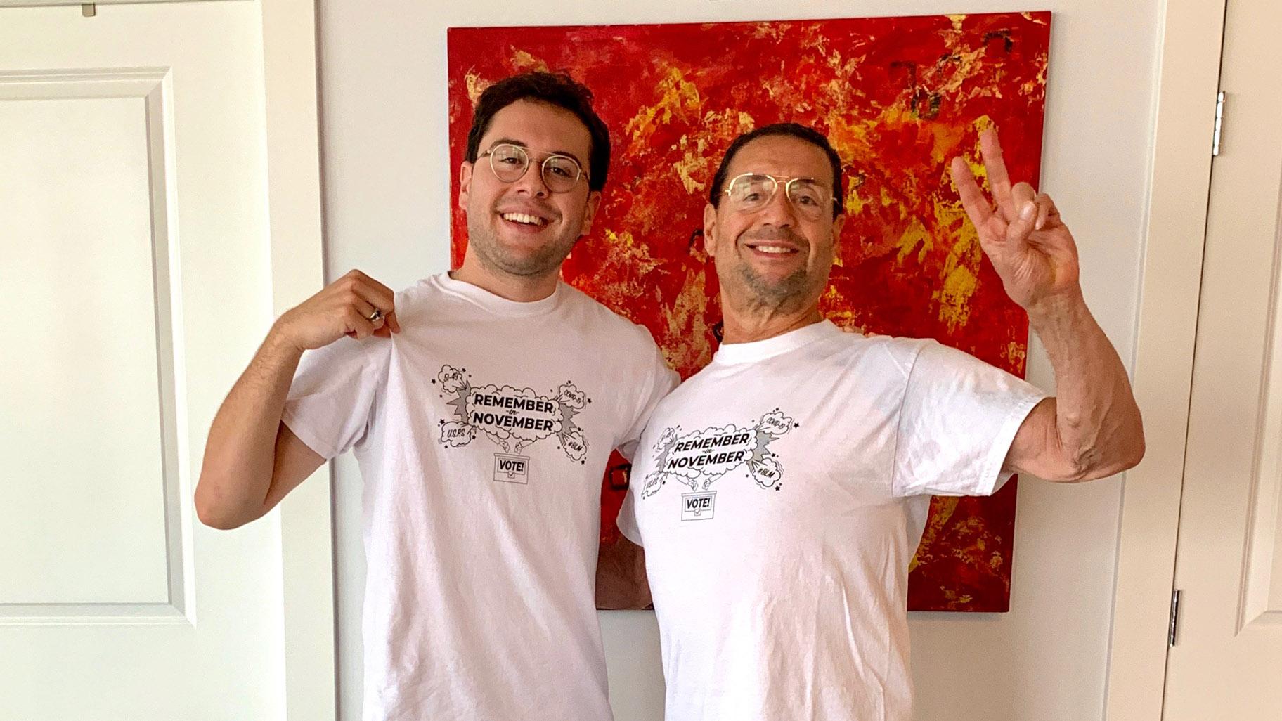 Horace Nowell III, left, and his father have their first in-person visit during the pandemic and show off their T-shirts. In the background is a painting the two made together. (Courtesy Horace Nowell)