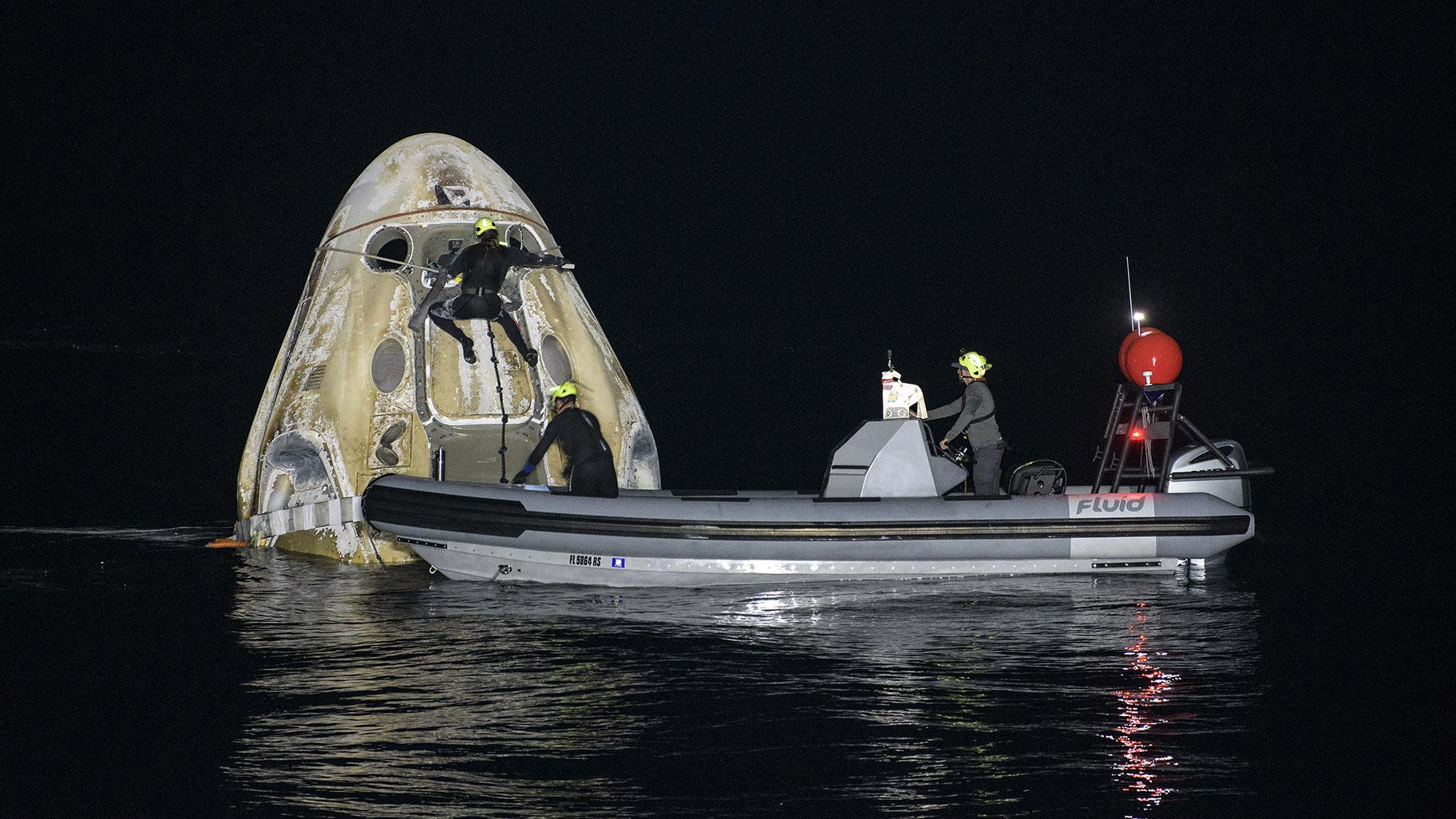 Support teams work around the SpaceX Crew Dragon Resilience spacecraft shortly after it landed with NASA astronauts Mike Hopkins, Shannon Walker, and Victor Glover, and Japan Aerospace Exploration Agency (JAXA) astronaut Soichi Noguchi aboard in the Gulf of Mexico off the coast of Panama City, Florida, Sunday, May 2, 2021. (Bill Ingalls / NASA via AP)
