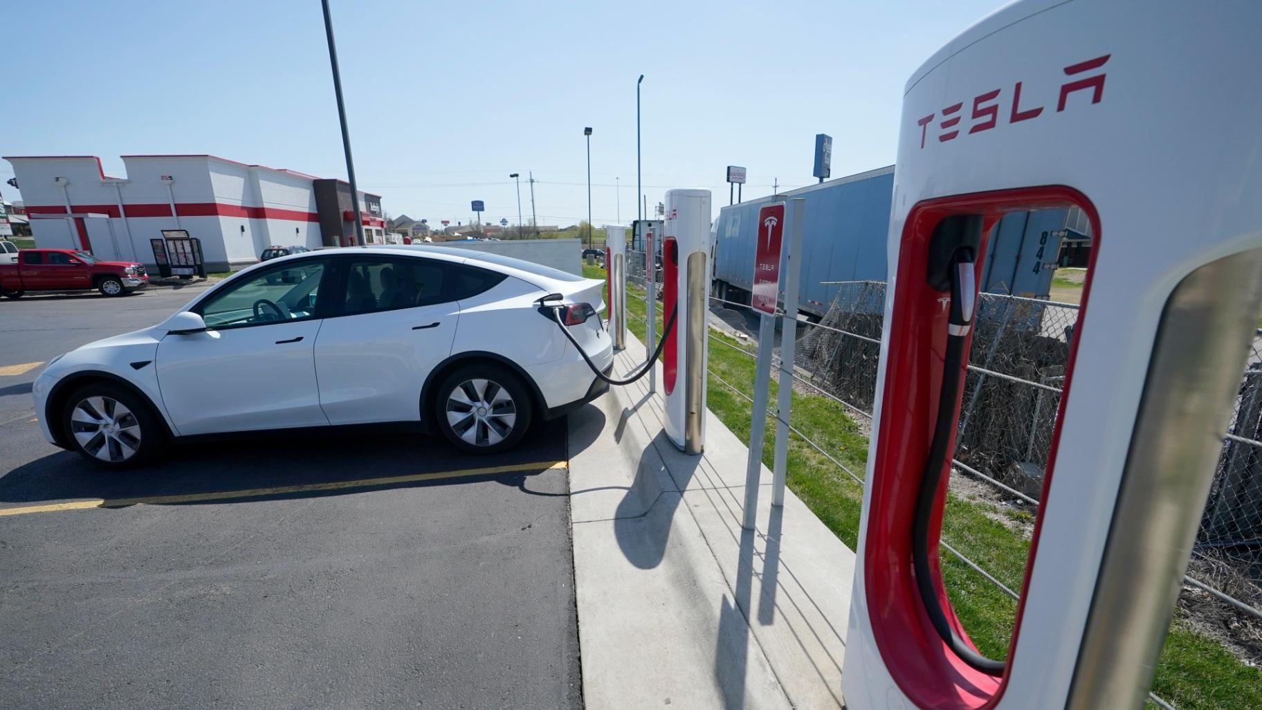 A Tesla charges at a station in Topeka, Kan., Monday, April 5, 2021. Tesla says it sold a record 1.3 million electric vehicles in 2022. (AP Photo / Orlin Wagner, File)