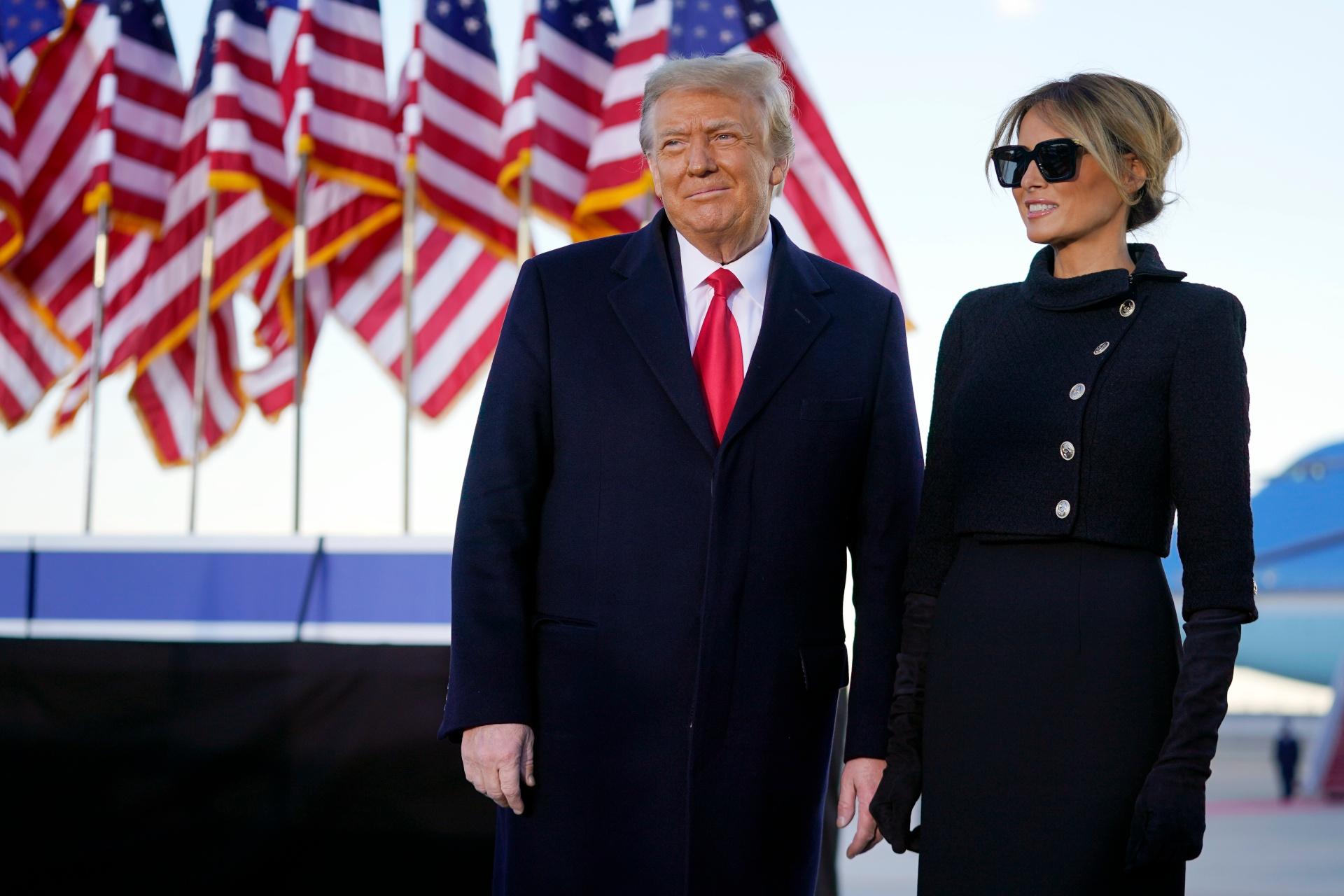 President Donald Trump and first lady Melania Trump look at supporters before boarding Air Force One at Andrews Air Force Base, Md., Wednesday, Jan. 20, 2021. (AP Photo / Manuel Balce Ceneta)
