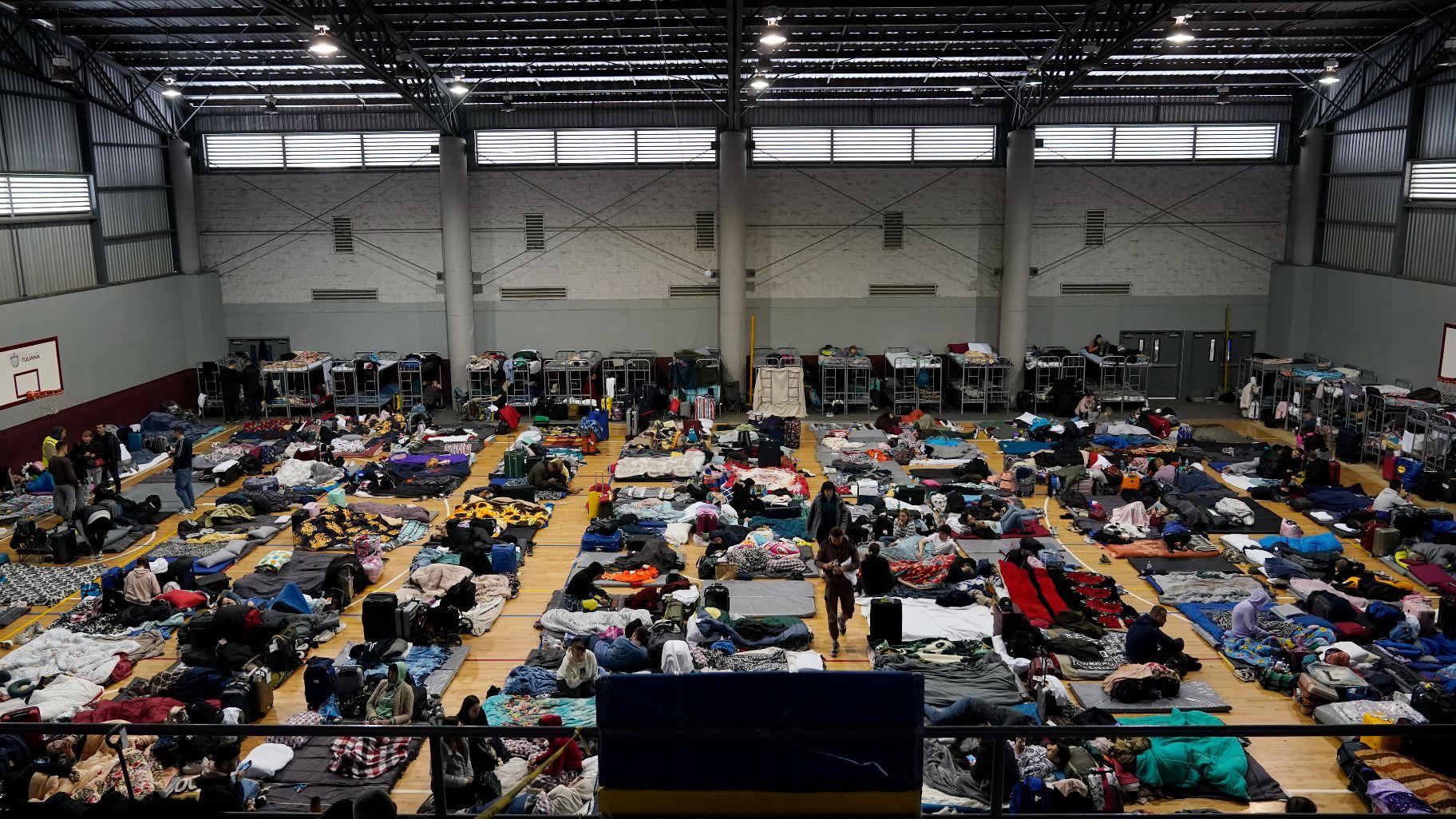  Ukrainian refugees wait in a gymnasium Tuesday, April 5, 2022, in Tijuana, Mexico. The Biden administration is allowing thousands of Ukrainians who fled their homeland when Russia invaded a year ago to stay in the United States longer. (AP Photo / Gregory Bull, File)