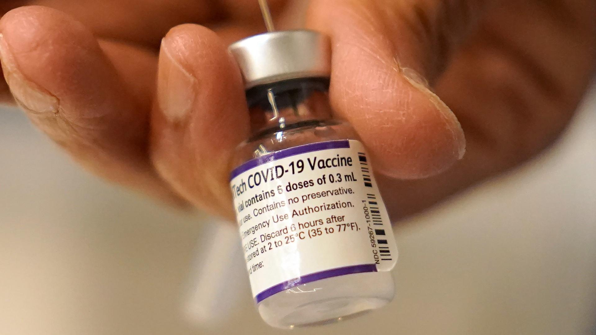 Dr. Manjul Shukla transfers Pfizer COVID-19 vaccine into a syringe, Thursday, Dec. 2, 2021, at a mobile vaccination clinic in Worcester, Mass. (AP Photo / Steven Senne, File)